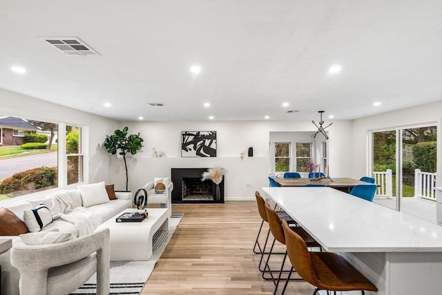 26 Parsons Dr, Swampscott, MA 01907 - living area with healthy amount of natural light, recessed lighting, light wood-style floors, a fireplace, and baseboards