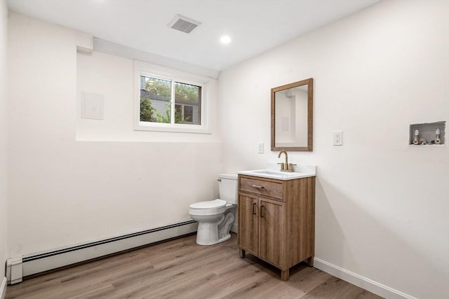 26 Parsons Dr, Swampscott, MA 01907 - bathroom featuring a baseboard radiator, toilet, vanity, wood finished floors, and recessed lighting