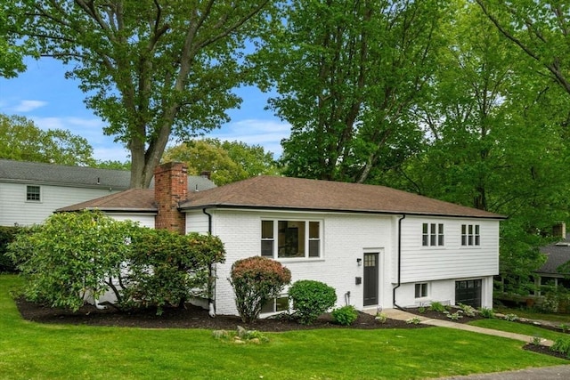 26 Parsons Dr, Swampscott, MA 01907 - split foyer home with brick siding, a front yard, a chimney, and a shingled roof
