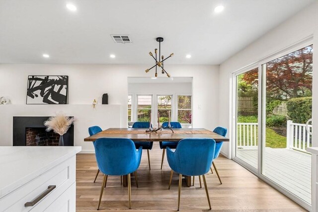 26 Parsons Dr, Swampscott, MA 01907 - dining space featuring light wood-type flooring, recessed lighting, and a fireplace with raised hearth