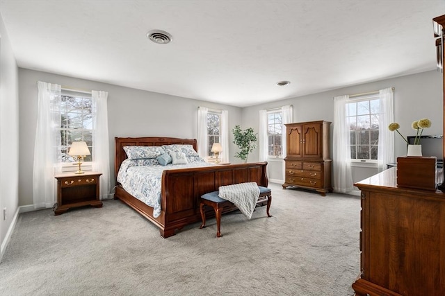 bedroom featuring light carpet, visible vents, and baseboards