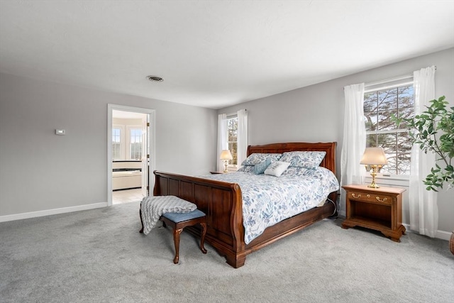 carpeted bedroom featuring visible vents, baseboards, and connected bathroom