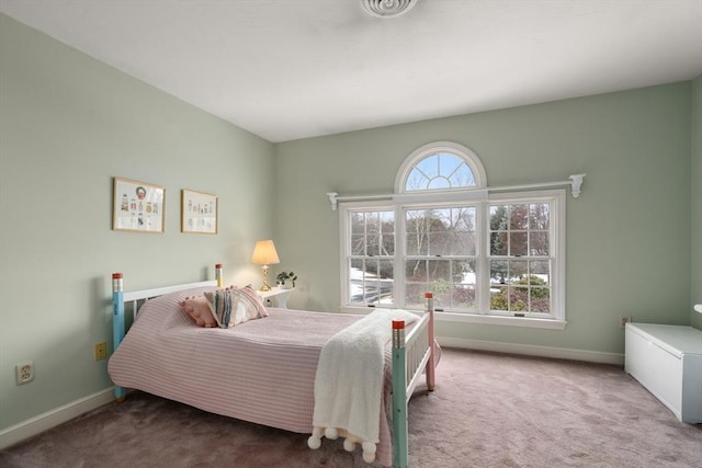 carpeted bedroom featuring baseboards