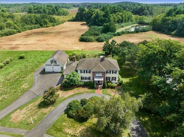 birds eye view of property with a wooded view