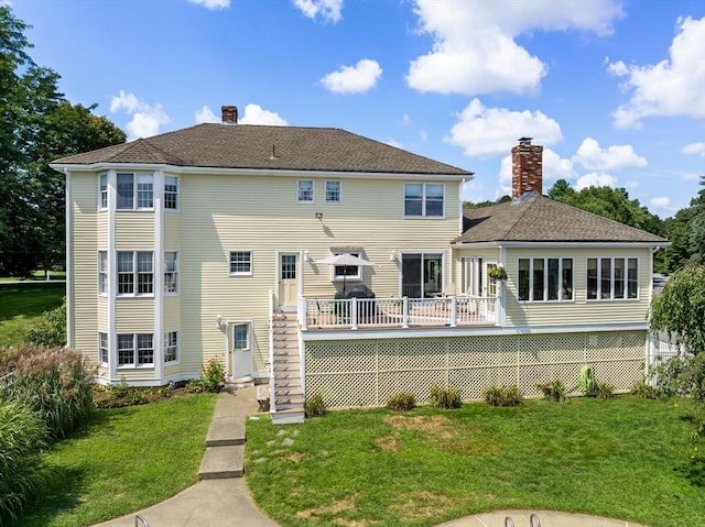 back of house with stairway, a lawn, a chimney, and a deck