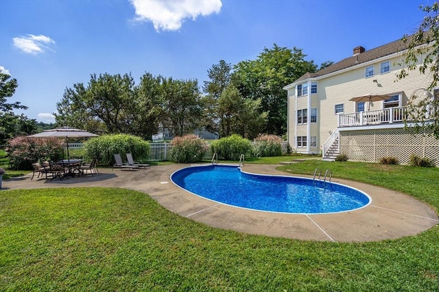 view of pool with a yard, a patio, fence, and a fenced in pool