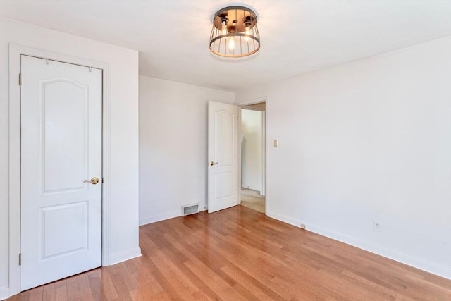 unfurnished bedroom with light wood-style floors and baseboards