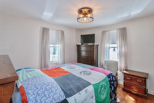 bedroom featuring wood finished floors and baseboards