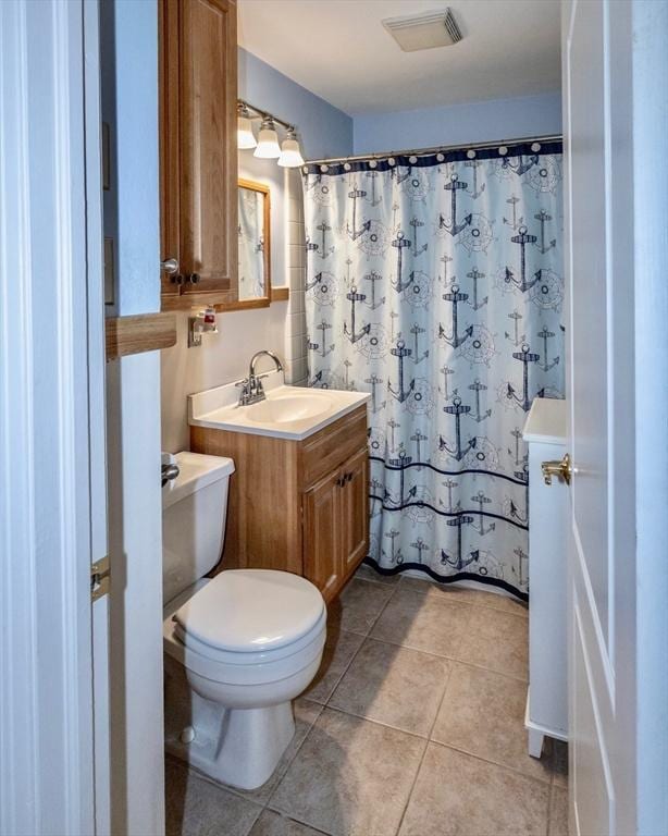full bath featuring toilet, tile patterned floors, vanity, and curtained shower