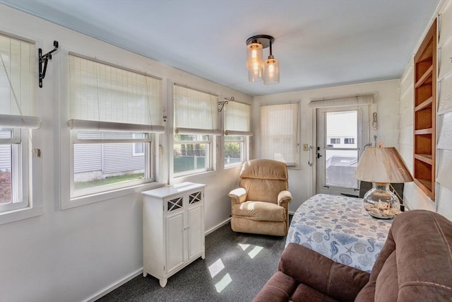 sitting room with baseboards and carpet floors