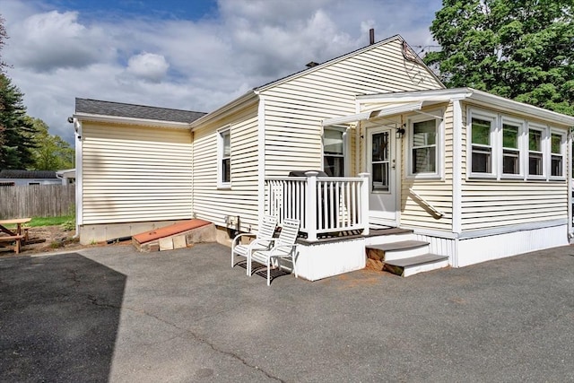 rear view of property with a patio area and fence