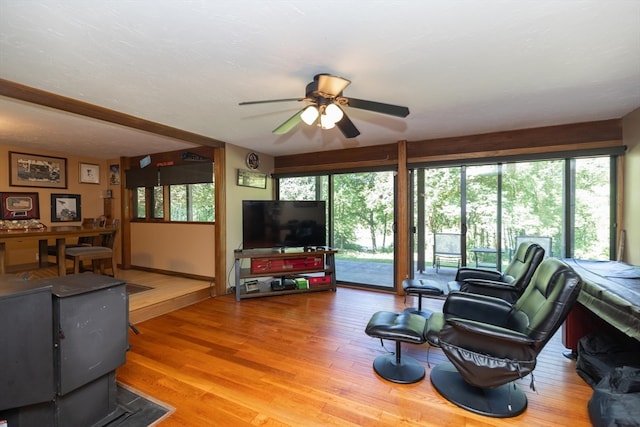 living room featuring hardwood / wood-style floors and ceiling fan