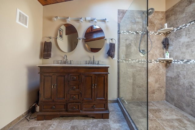 bathroom featuring vanity, lofted ceiling, and tiled shower