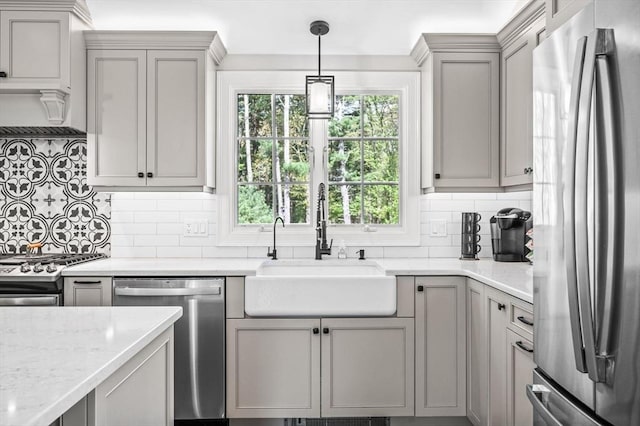 4 Rowley Rd, Topsfield, MA 01983 - kitchen featuring stainless steel appliances, a sink, gray cabinetry, backsplash, and light stone countertops