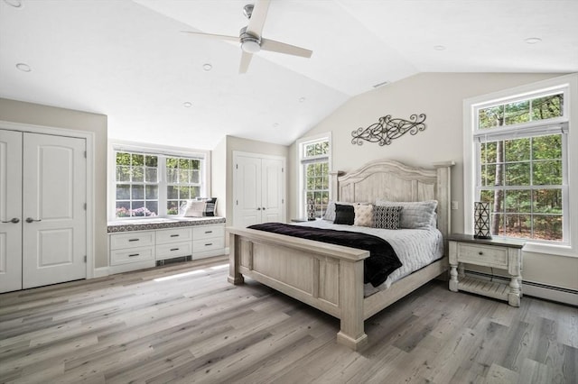 4 Rowley Rd, Topsfield, MA 01983 - bedroom with two closets, light wood-style flooring, vaulted ceiling, a ceiling fan, and a baseboard heating unit
