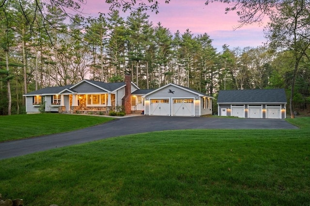 4 Rowley Rd, Topsfield, MA 01983 - ranch-style home with an outbuilding, a chimney, a front yard, asphalt driveway, and a garage