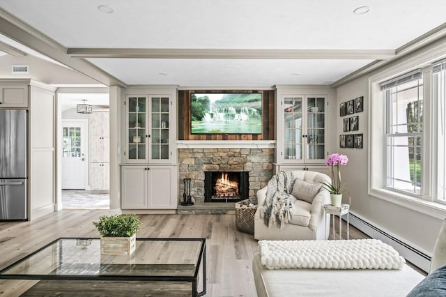 4 Rowley Rd, Topsfield, MA 01983 - living room with a baseboard radiator, wood finished floors, beam ceiling, a fireplace, and baseboards