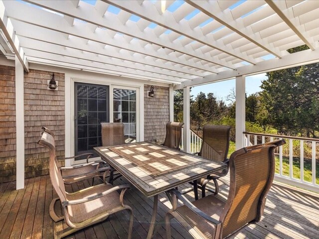 wooden deck featuring a pergola and outdoor dining space