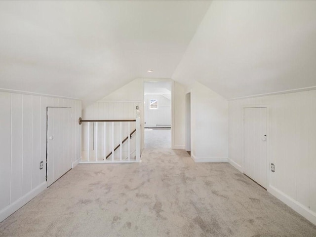 additional living space featuring lofted ceiling, baseboards, and carpet floors