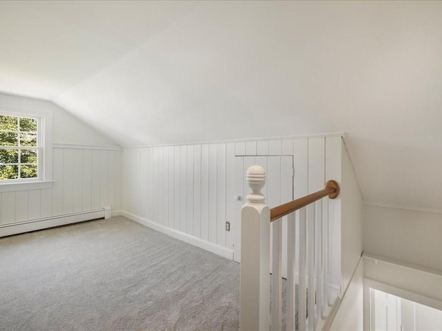 additional living space with lofted ceiling, carpet, and baseboard heating