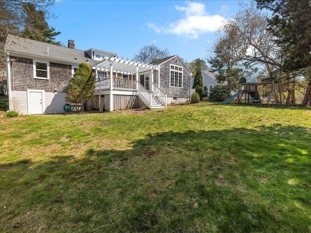 rear view of property with a pergola, a lawn, a playground, and a chimney