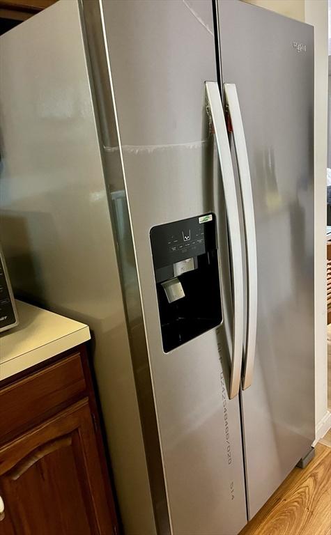 interior details with stainless steel fridge and light countertops