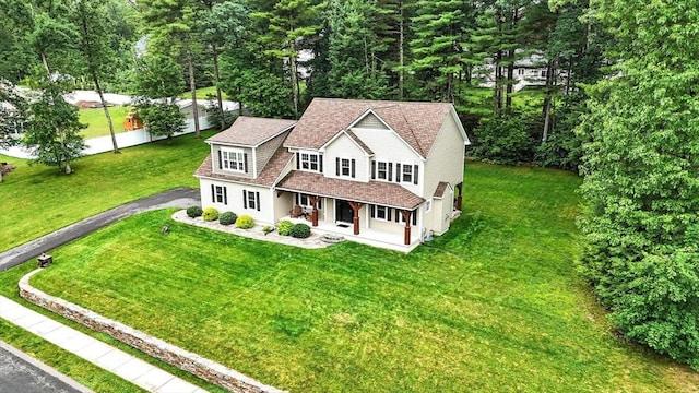 21 Carla Ln, Wilbraham, MA 01095 - view of front facade featuring driveway, covered porch, a front lawn, and a shingled roof