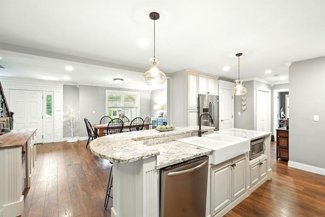 21 Carla Ln, Wilbraham, MA 01095 - kitchen with appliances with stainless steel finishes, an island with sink, dark wood-style floors, recessed lighting, and ornamental molding