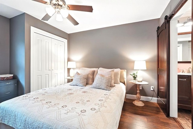 21 Carla Ln, Wilbraham, MA 01095 - bedroom with a barn door, dark wood-style floors, a closet, and a ceiling fan