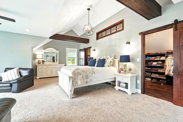 21 Carla Ln, Wilbraham, MA 01095 - carpeted bedroom featuring a barn door, vaulted ceiling, a spacious closet, and a chandelier