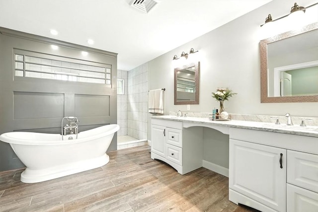 21 Carla Ln, Wilbraham, MA 01095 - bathroom featuring double vanity, wood finished floors, a soaking tub, and a walk in shower