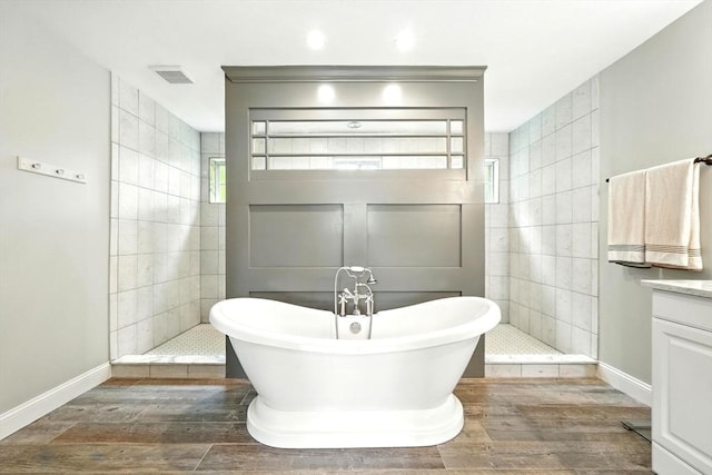 21 Carla Ln, Wilbraham, MA 01095 - full bath featuring a freestanding tub, walk in shower, and wood finished floors