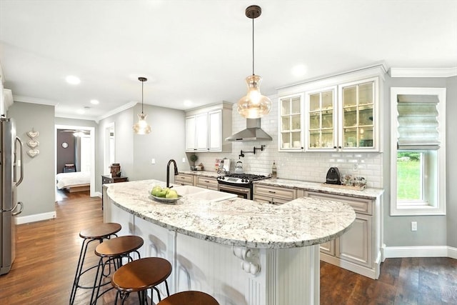 21 Carla Ln, Wilbraham, MA 01095 - kitchen with stainless steel appliances, ornamental molding, tasteful backsplash, dark wood-type flooring, and an island with sink
