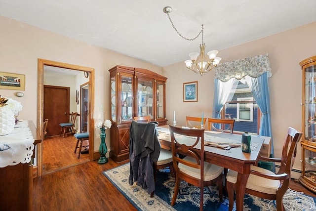 dining room featuring a notable chandelier and dark wood finished floors