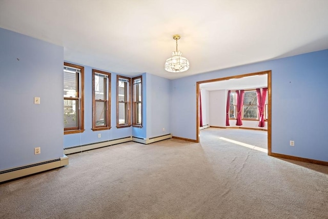 carpeted spare room featuring baseboards and a baseboard radiator