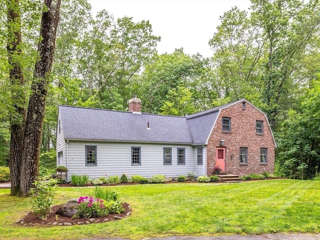 9 Horseshoe Rd, Chelmsford, MA 01824 - view of front of home featuring a chimney, roof with shingles, a front yard, and a gambrel roof