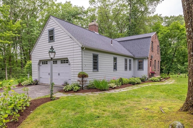 9 Horseshoe Rd, Chelmsford, MA 01824 - view of side of home featuring roof with shingles, a chimney, a yard, driveway, and view of wooded area