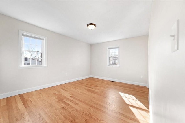 empty room featuring light wood-style flooring and baseboards