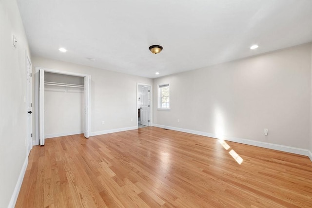 unfurnished bedroom featuring recessed lighting, light wood-type flooring, and baseboards