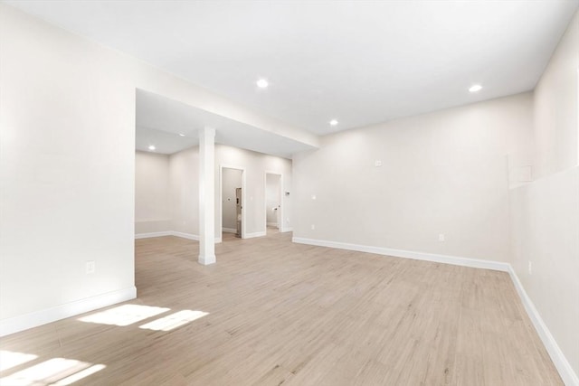 below grade area with light wood-style floors, baseboards, and recessed lighting