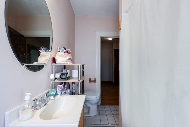 bathroom featuring tile patterned floors, vanity, toilet, and a shower with shower curtain