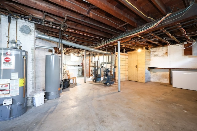 basement with water heater and white fridge