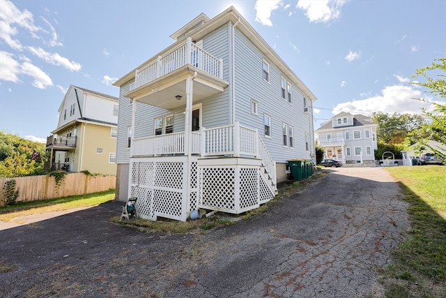 back of house with a balcony