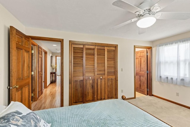bedroom with a closet, a ceiling fan, and baseboards