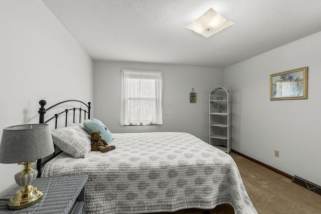 carpeted bedroom featuring baseboards and visible vents