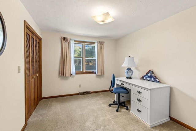 office with baseboards, light carpet, and visible vents