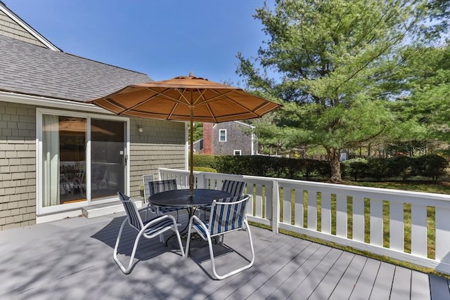 wooden deck featuring outdoor dining area