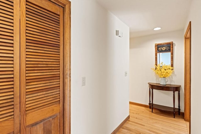 hall featuring recessed lighting, baseboards, and light wood finished floors