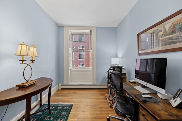 office area featuring a baseboard radiator and light hardwood / wood-style flooring