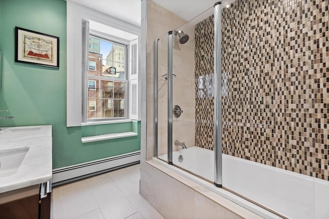 full bath featuring baseboard heating, tiled shower / bath combo, and vanity